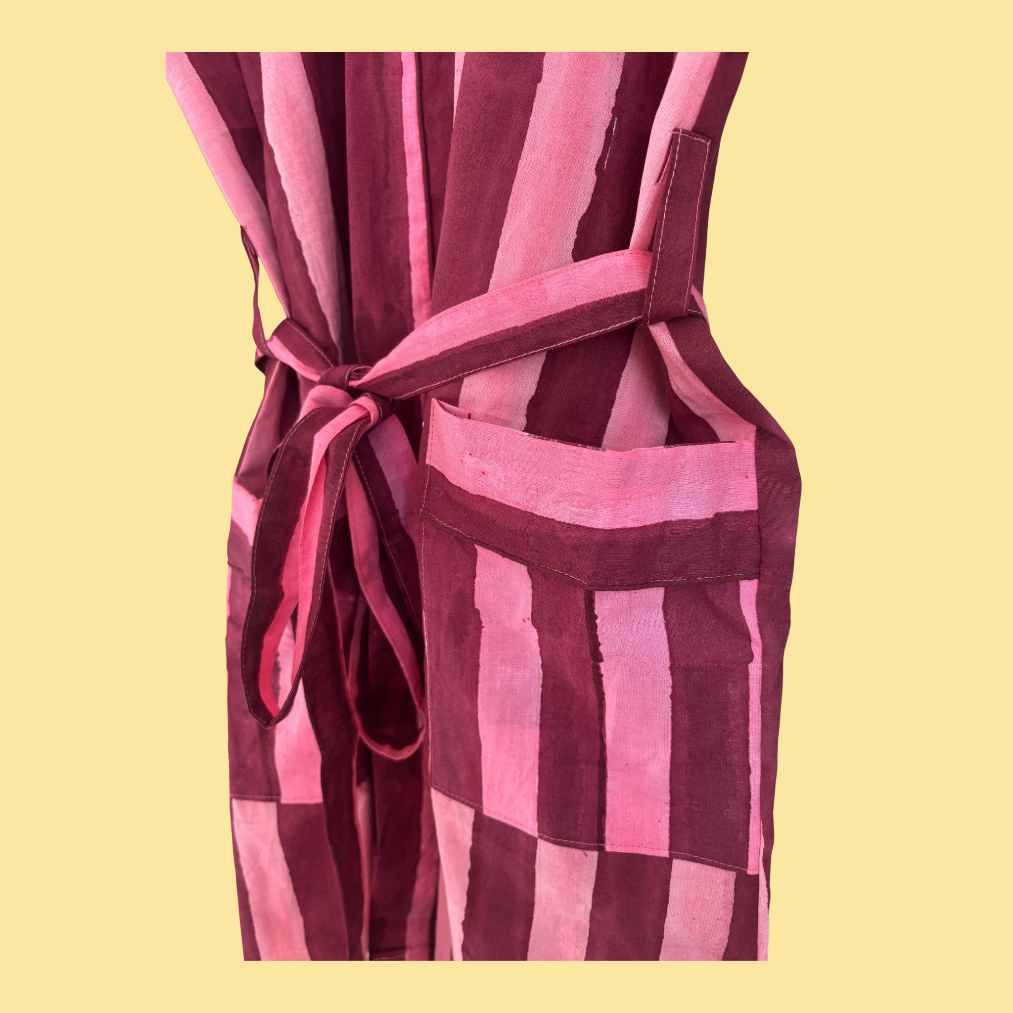 J P & Co. Pink & Burgundy Striped Kimono (Short) Pocket Detail on a yellow background