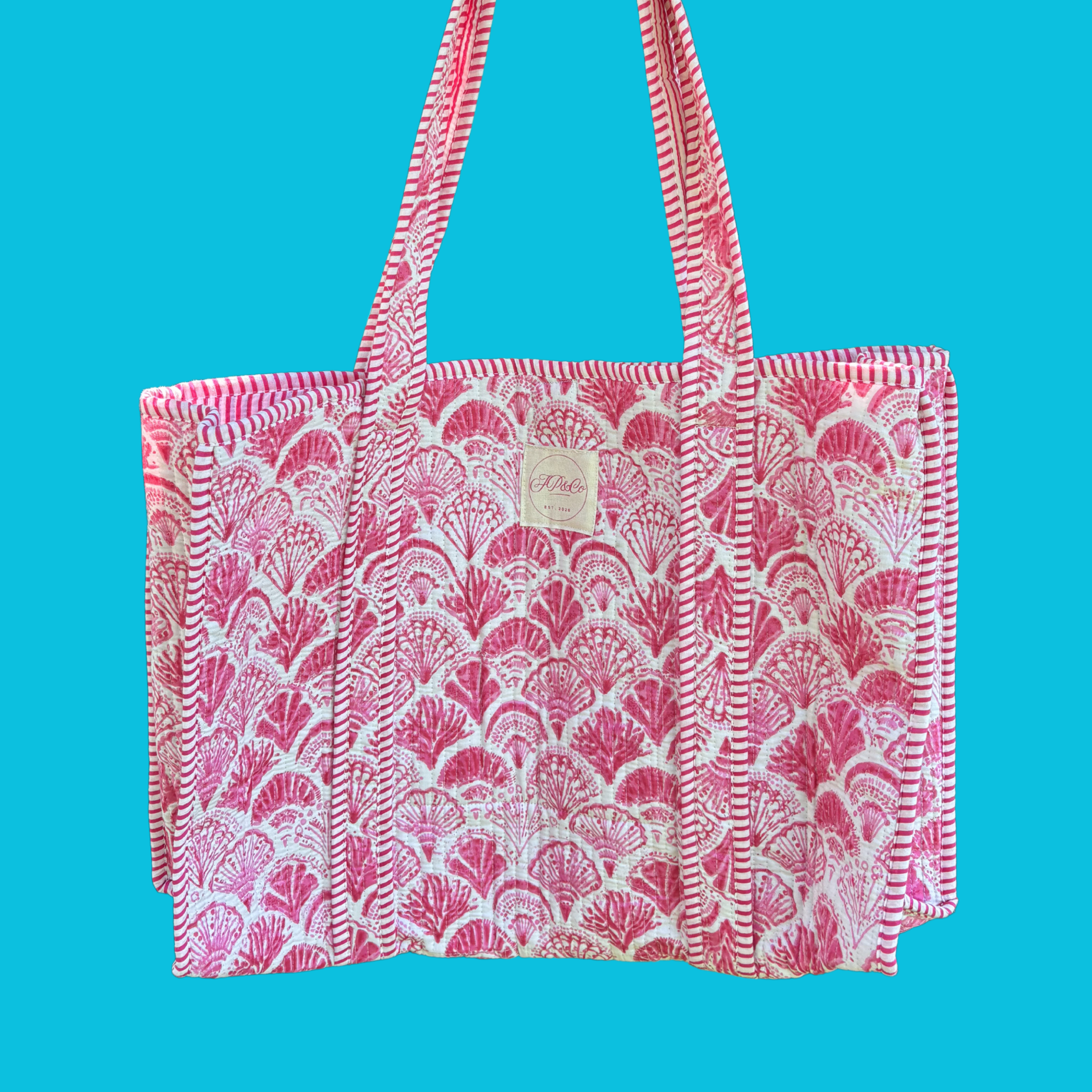 Pink and white shell tote bag on blue background